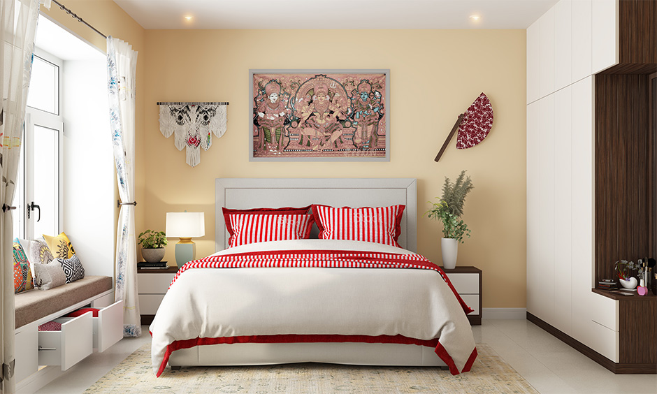 Durga puja simple decoration for bedroom with a red and white bedsheet and pillow covers lends Bengali touch