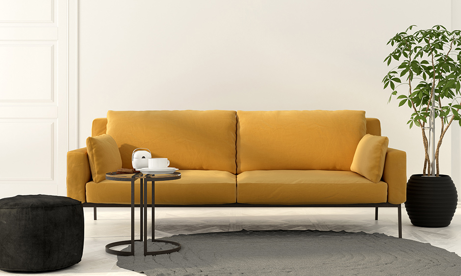 Mustard loveseat with cushions on each side