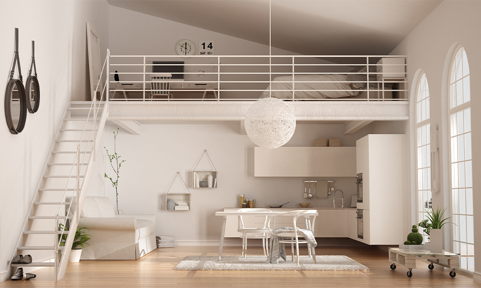 Loft bedroom design in cosmopolitan style with a small study table and floating stairs lends an airy vibe