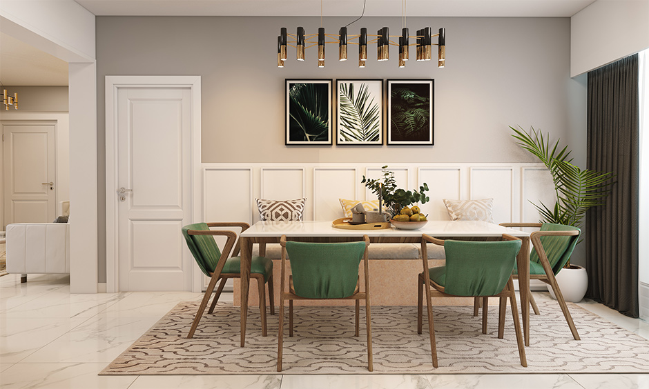 A wooden white dining table set paired with green chairs