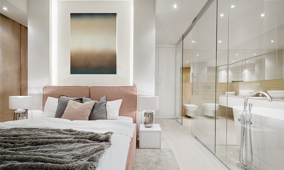 Bathroom glass partition sliding into the bedroom makes the entire area look spacious and airy