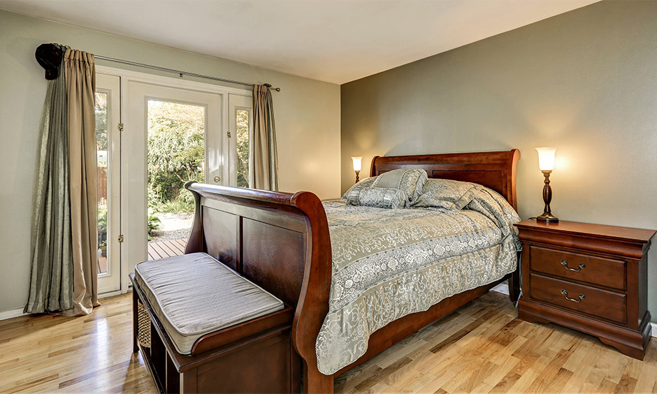 A vintage bedroom with a classic wooden bed with a curved headboard adds a great appeal to the vintage bedroom design