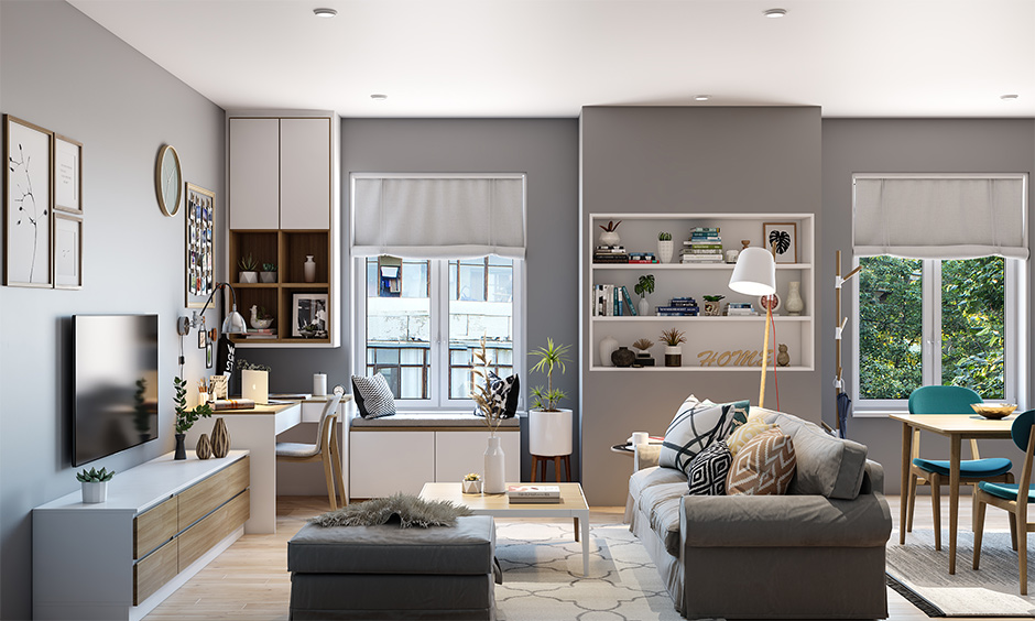 Small cozy apartment living room features natural wood flooring, white and light grey-themed furniture