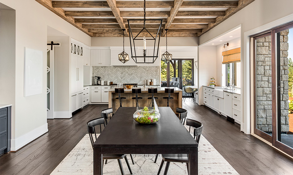 Traditional dining room table in a black wooden style makes it look appealing with curved back chairs