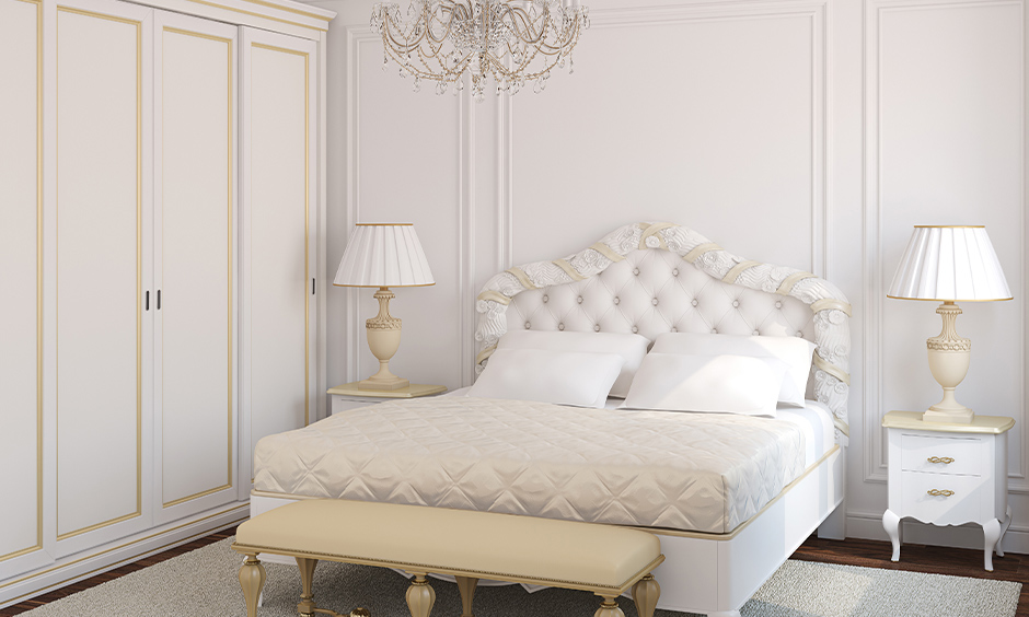 All white vintage bedroom with a tufted white framed headboard adds lavishness to the bedroom