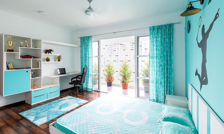 A bright bedroom with balcony comes with a tall railing design that keeps the space semi-open