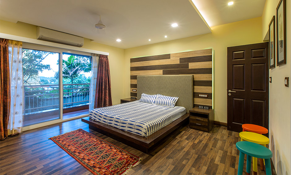 Indian bedroom with balcony and a large sliding window opens to a small but beautiful balcony space