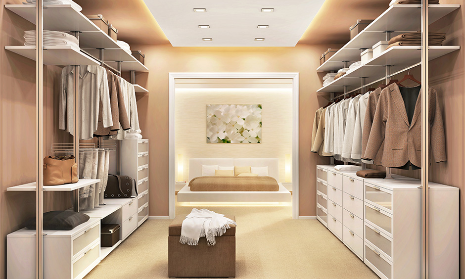 Light brown painted walk in wardrobe in dressing room