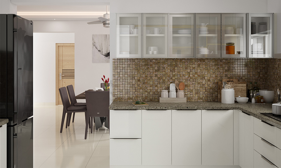 Wall to wall glass showcase design for a kitchen lends a clutter-free look and ideal showcase design for an apartment