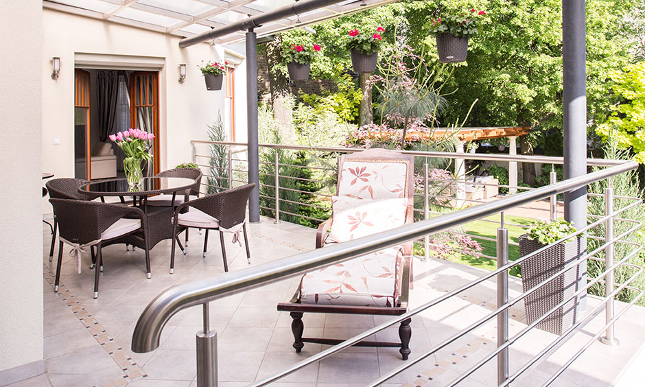 Balcony false ceiling design with glass and metal which makes a perfect place to enjoy dinner outside