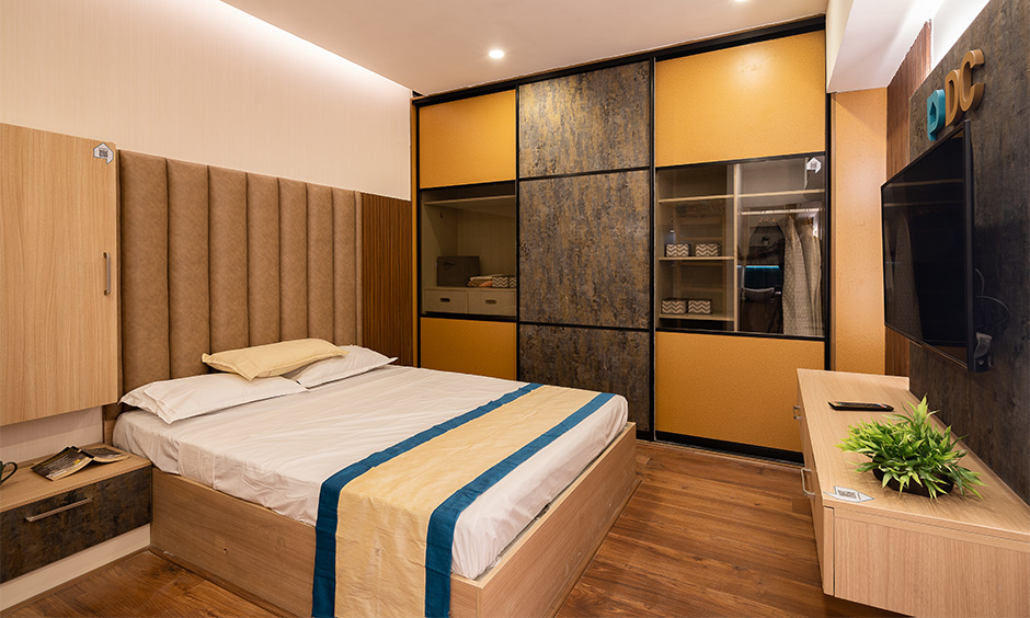 Elegant bedroom design at Chennai interior design experience center featuring wall-to-wall wardrobe