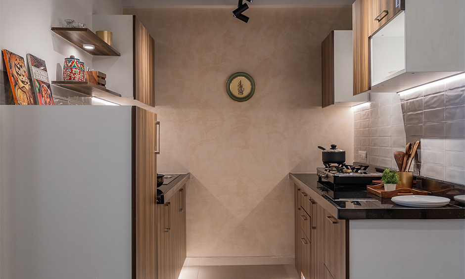 The modern wooden kitchen at Chennai interior studio center with an earthy accent wall gives traditional touch