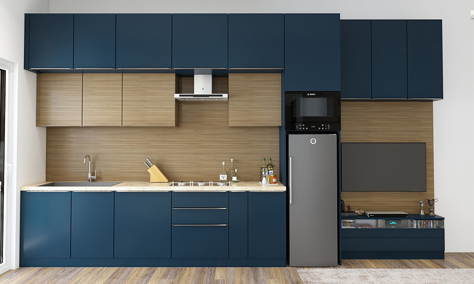 Navy blue is a trending cabinet color that looks superb with metallic accents and wooden flooring