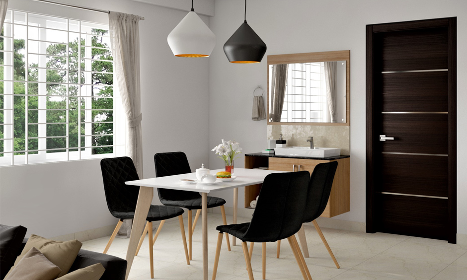 Simple black and white dining table with upholstered chairs in a classic