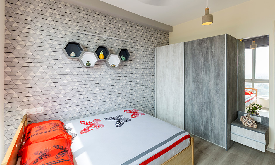 A compact grey bedroom incorporated the industrial vibe with the wallpaper pattern of an exposed brick wall