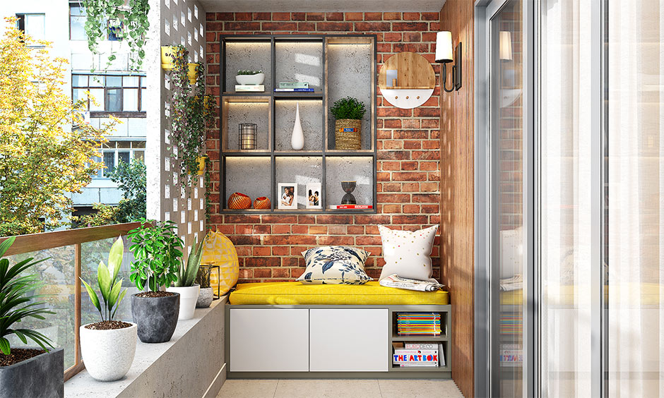 Apartment balcony decor with comfy bench and exposed brick wall makes for a great backdrop