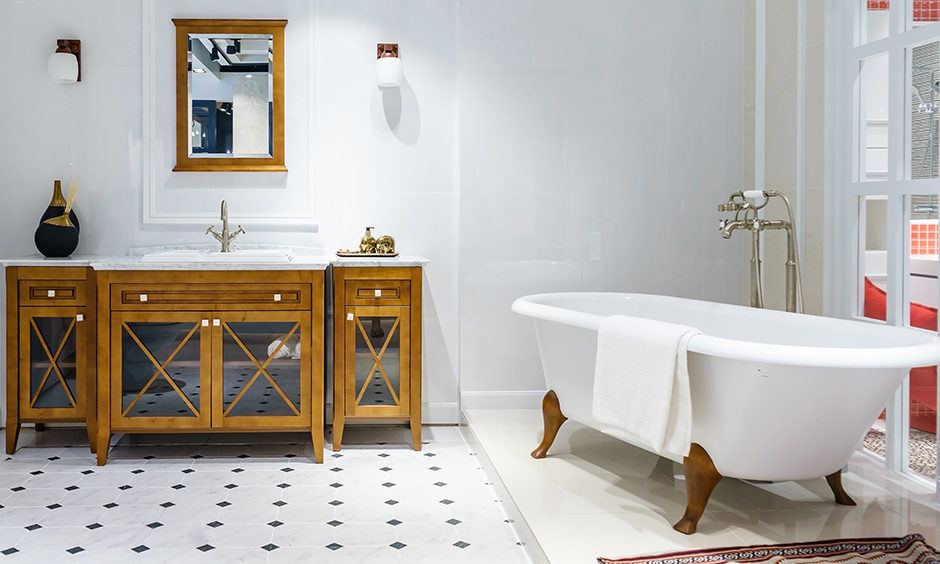 Traditional bathroom design with clawfoot bathtub and wooden vanity