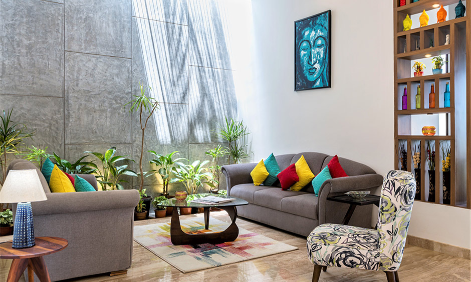 A boho living room with grey couch gives you a tropical and beachy vibe