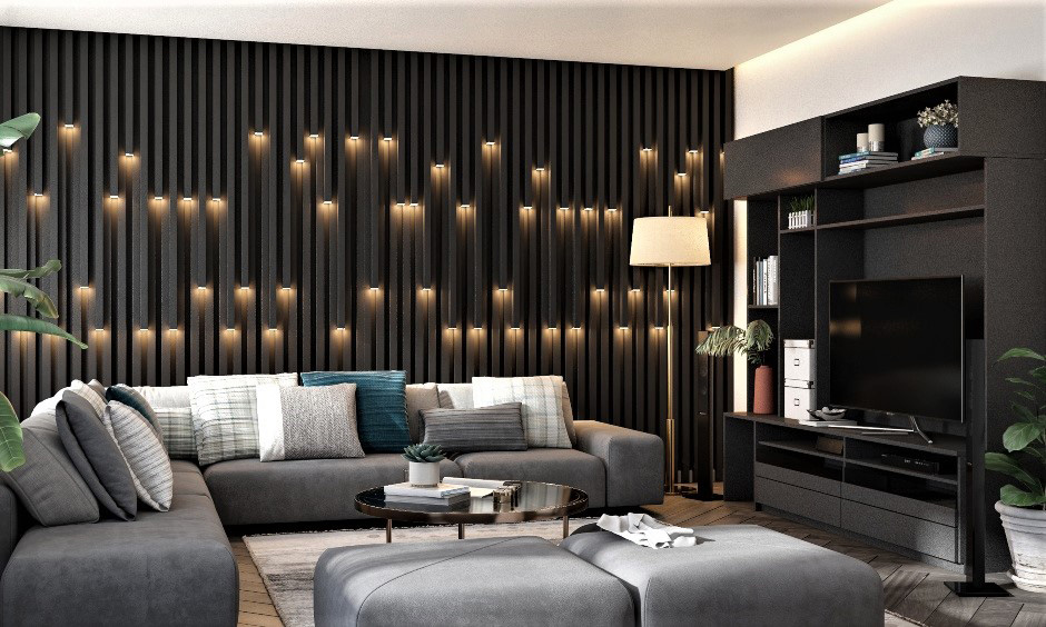 The L-shaped grey couch in the living room paired with a dark accent wall and unique ambient lighting oozes perfection