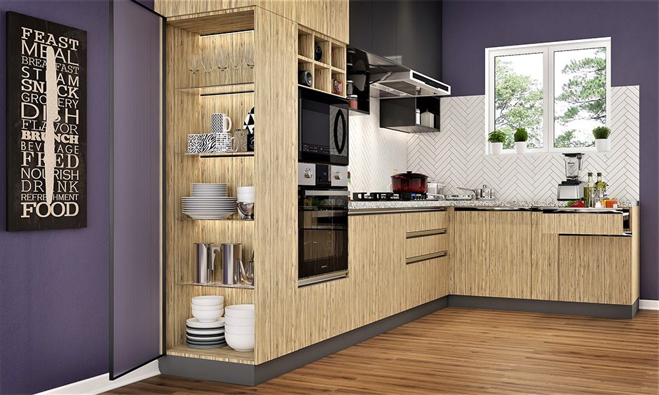 The purple kitchen colour with light brown cabinets makes the kitchen feel more inviting