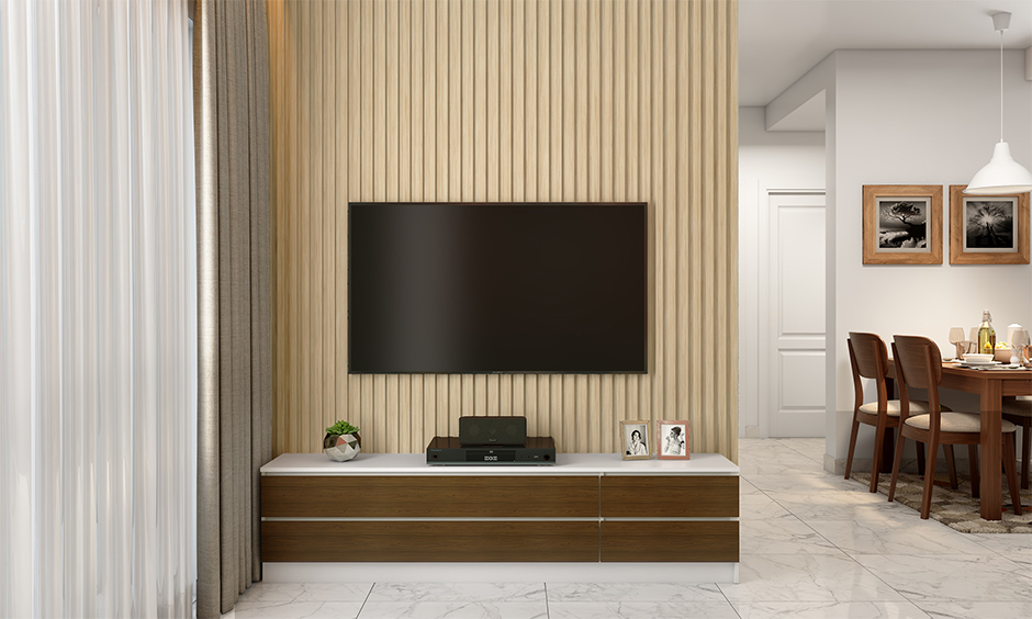 A simple living room tv wall unit designed in clean white and veneer wooden finish adds charm