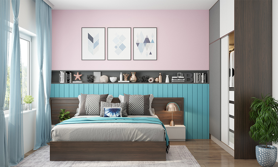 Turquoise detail in a light pink bedroom design with dark grey shelf and turquoise wooden panels