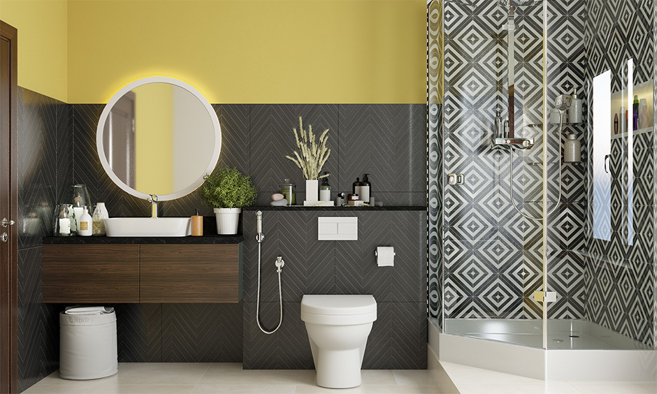 A yellow bathroom paint with monochrome wall tiles creates a striking contrast