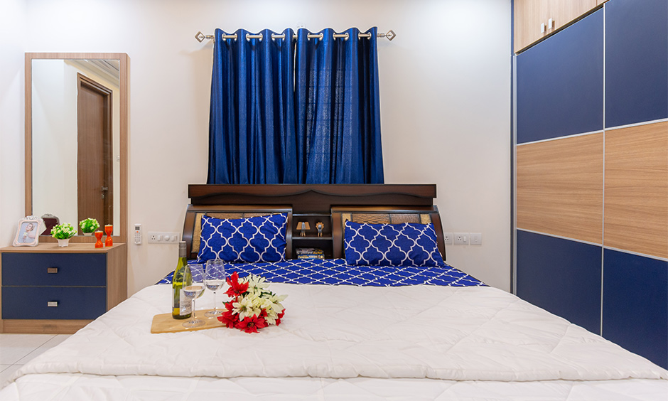 3bhk interior design in Kondapur Hyderabad designed a master bedroom with a blue and wood theme defines elegance