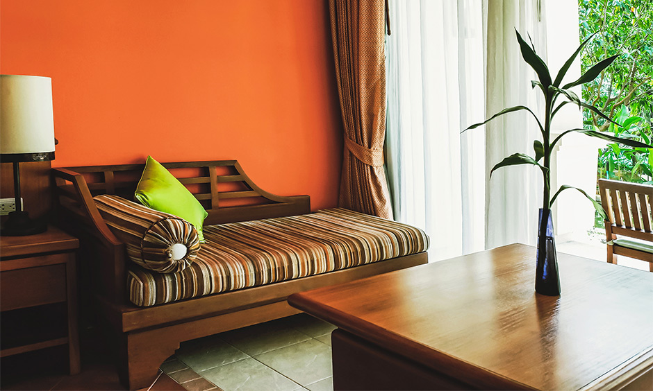 A coffee and white sheer curtain combination for the orange wall carries a vintage lure