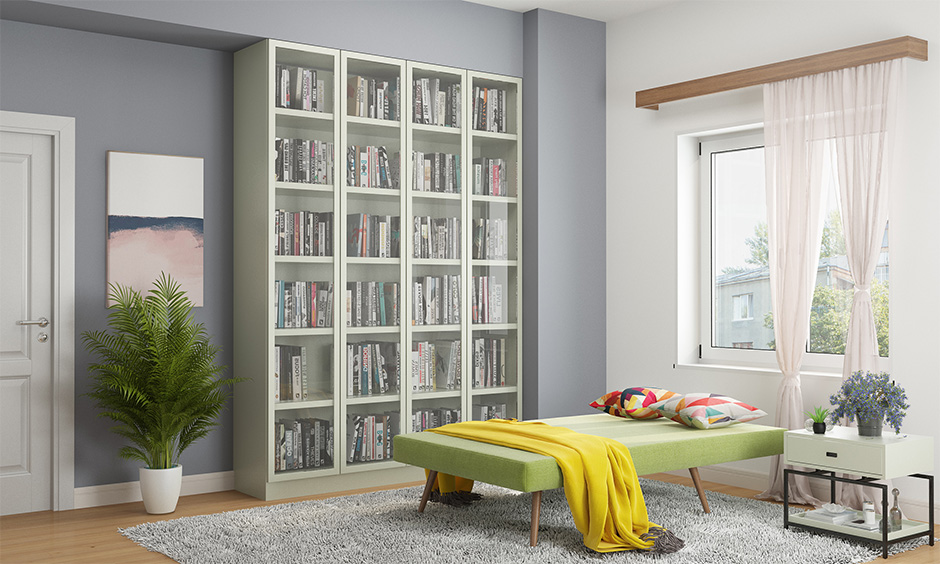 A reading nook with a green coloured semi sleeper chair