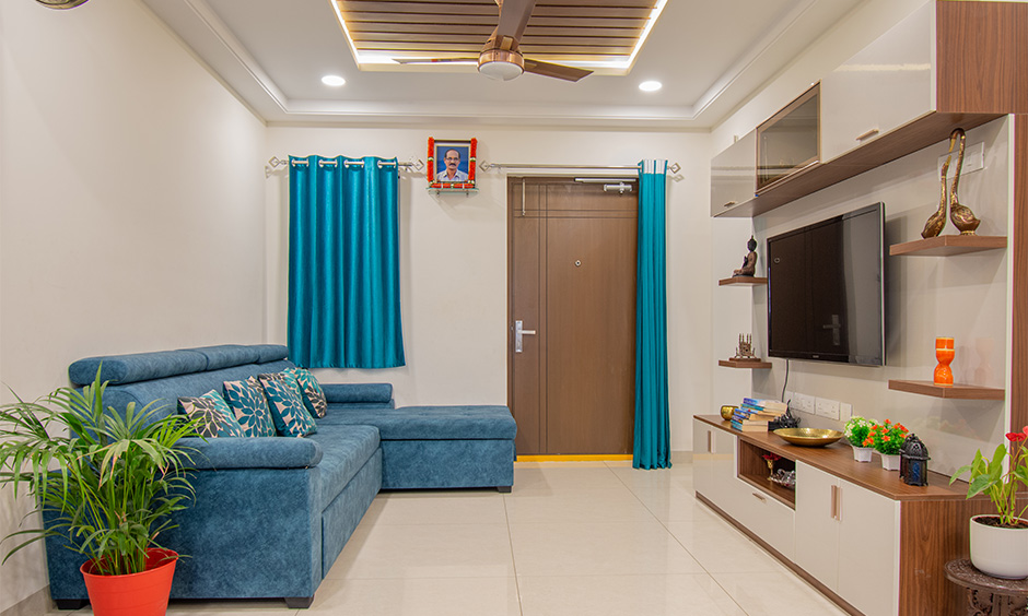 Top interior designer in Hyderabad Kondapur area for 3bhk multi-functional living room featuring a tv unit and sofa