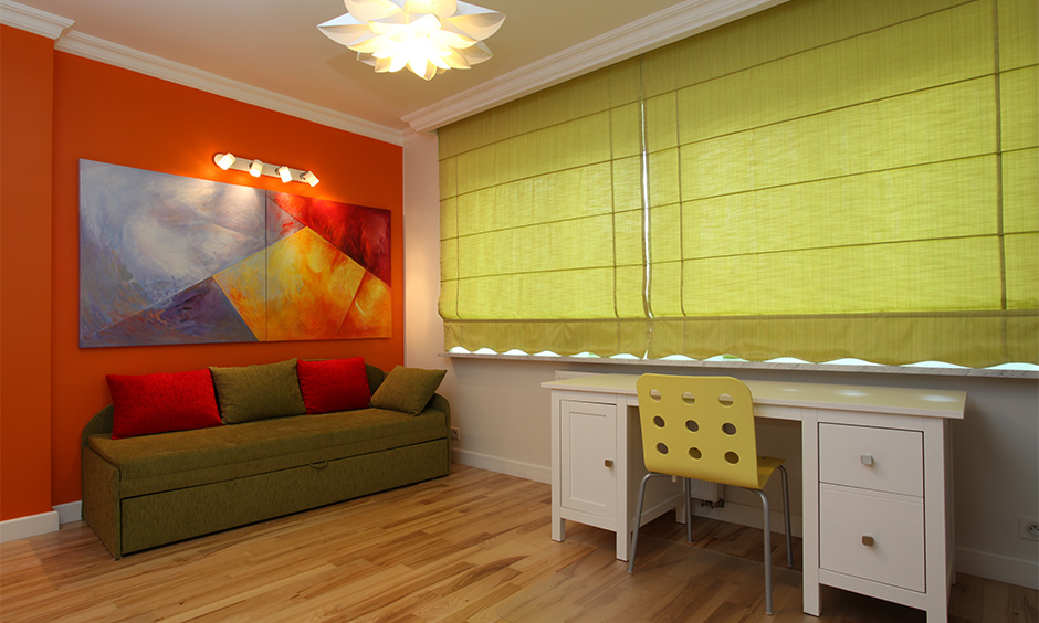 Oliva's green curtain color for the orange wall gives a sense of hope