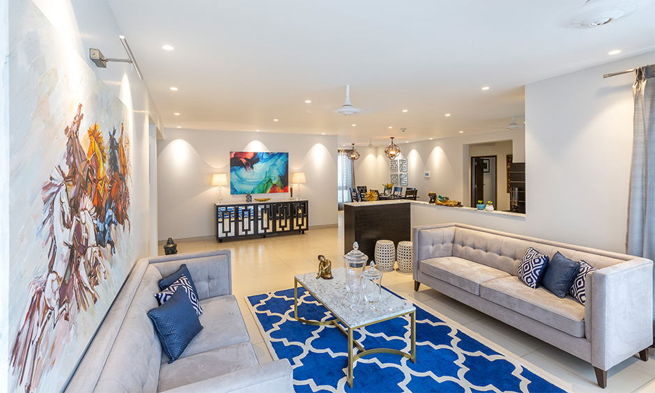 An eclectic living room decor with cream couch, marble coffee table, and accent pieces