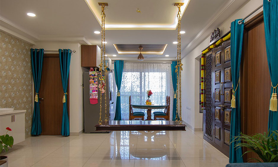 Best interior designers in Hyderabad Kondapur designed a 3 bhk traditional indoor swing and ornate pooja room door