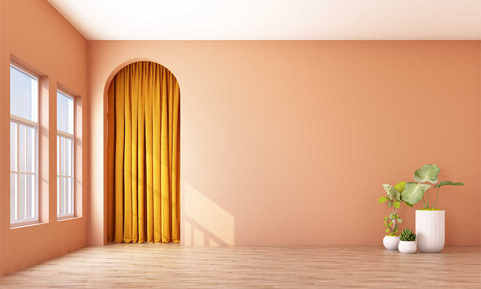 Yellow curtain color for the orange wall gives an exciting look to the space