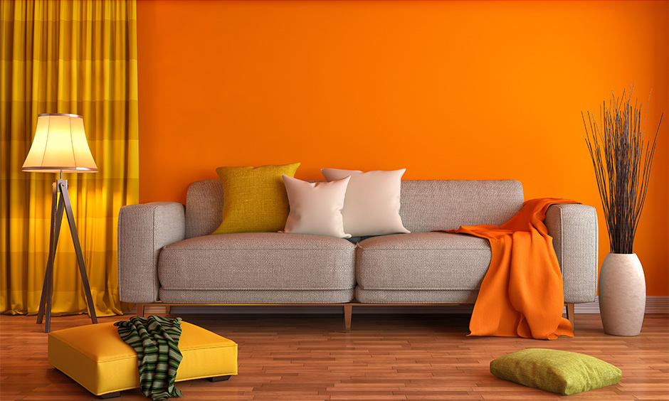 Yellow curtain for the orange wall matches well and brings excitement to the space