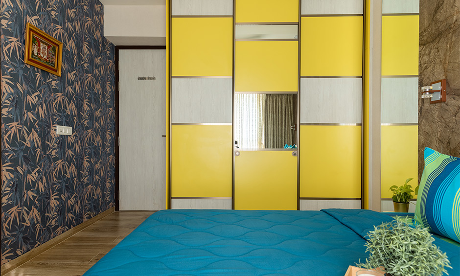 3bhk bedroom interior design service in Mulund, Mumbai incorporated with floor-to-ceiling wardrobe in yellow