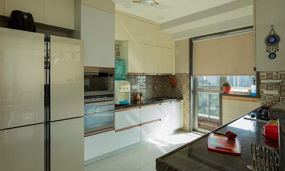 A sleek kitchen design with an extra appliance garage by interior designers in south mumbai