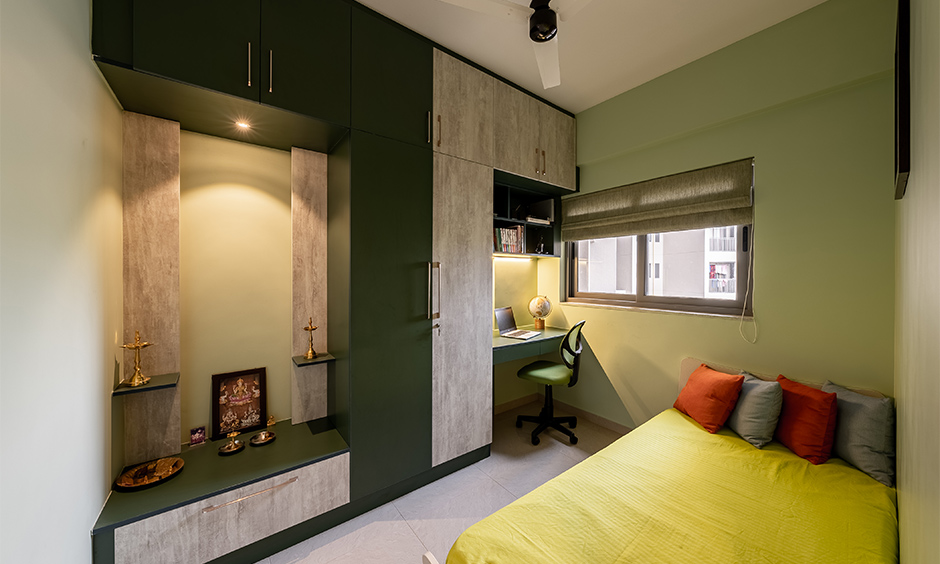 A bedroom wardrobe with a study table and puja unit attached gives a lovely nook