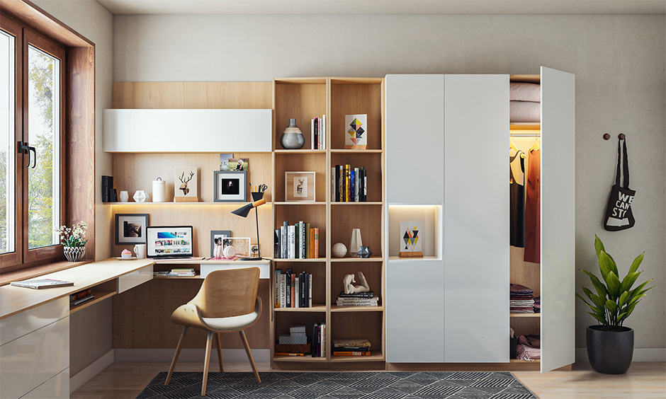 An L-shaped study home office setup with an attached bookshelf allows for a spacious and clutter-free experience