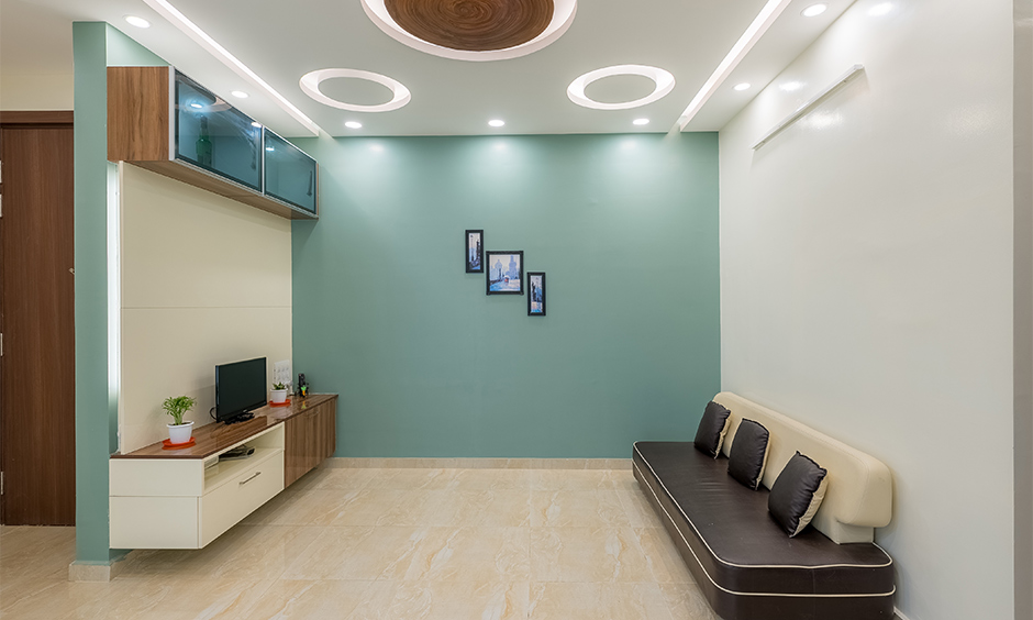 A luxury home interior on a budget with a false ceiling with cove light is a minimalistic yet luxurious living room