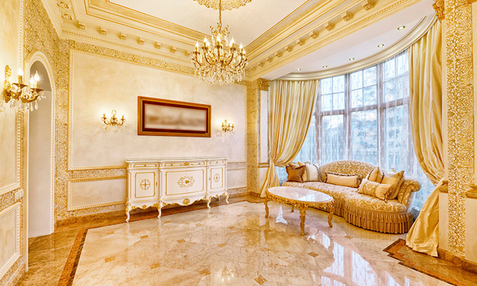 Victorian living room in gold and white tones helps keep the design style posh with elegant furniture