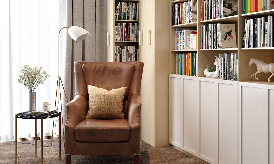 Brown leather reading chair next to bookshelves in the cosy reading space