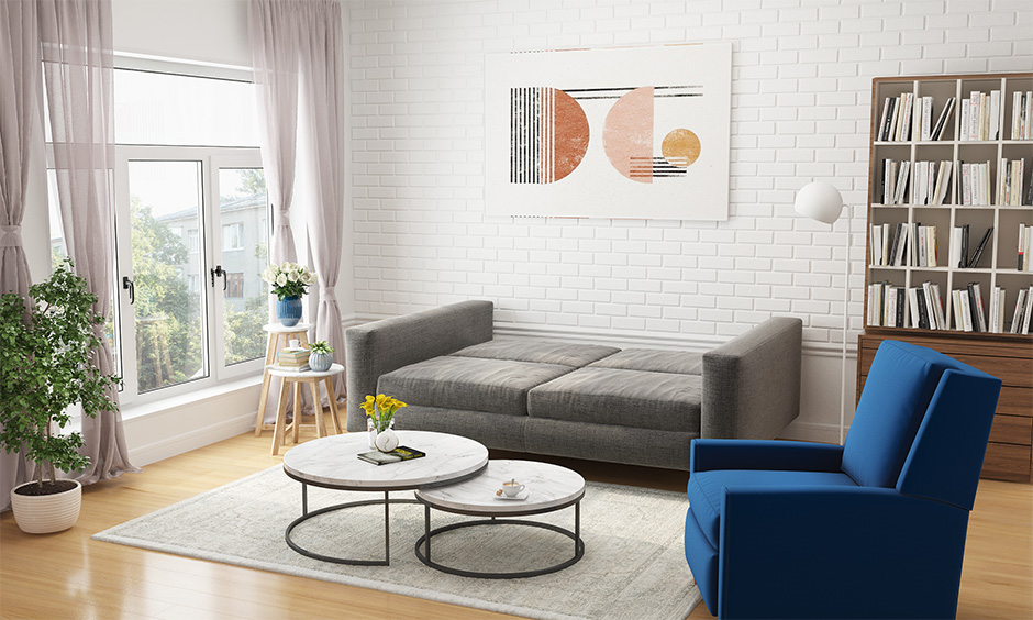 A full-sized grey sleeper sofa paired with a white faux fur rug in living room