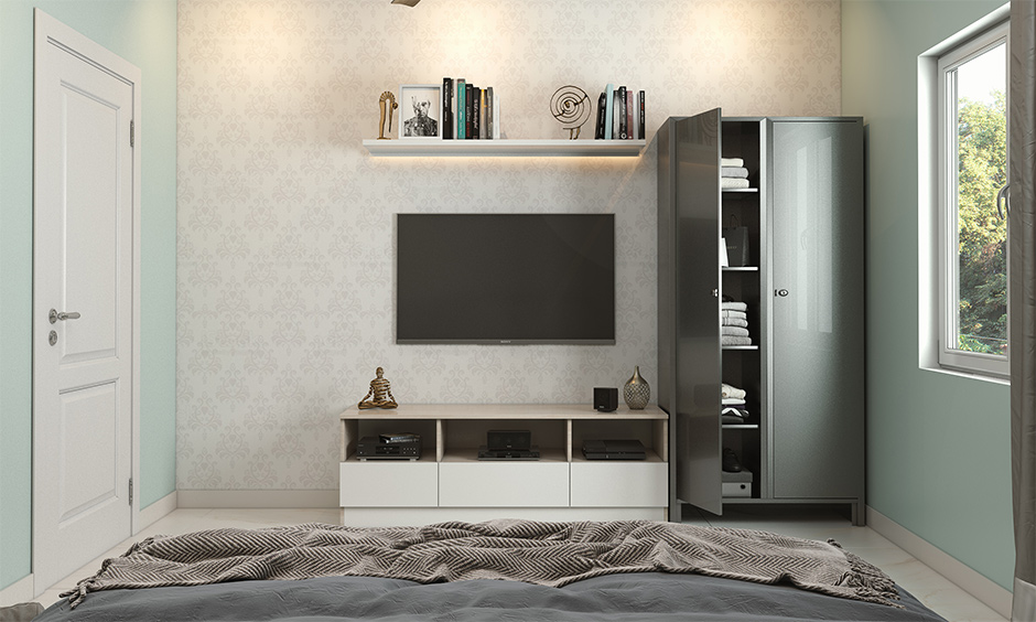 Steel wardrobe design in grey next to the tv unit in a glossy finish