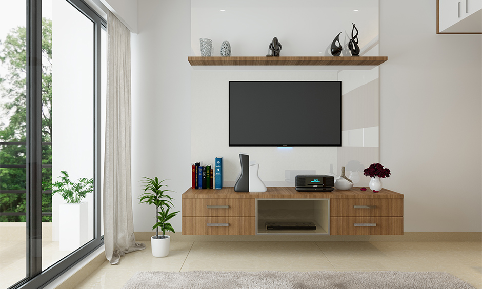 Wooden tv cabinet design for living room lends to house all the TV-related paraphernalia and magazines