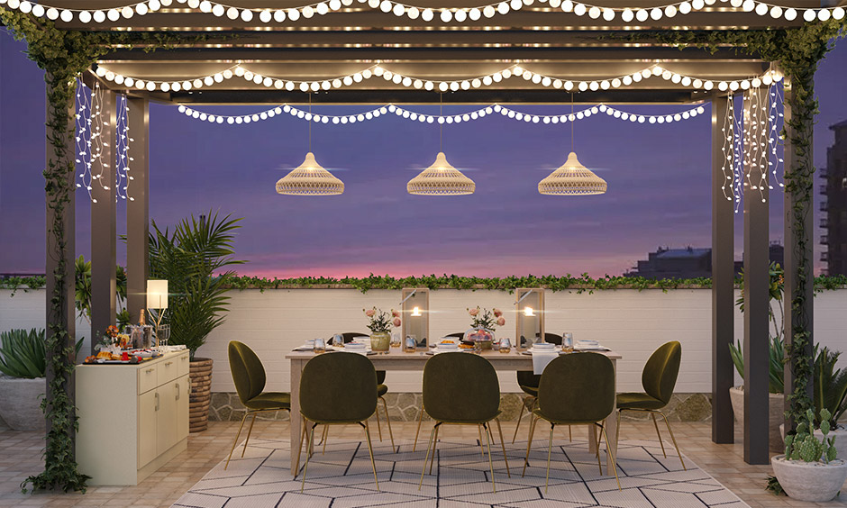 Cool pendant lamps and string lights are arranged in outdoor dining setup