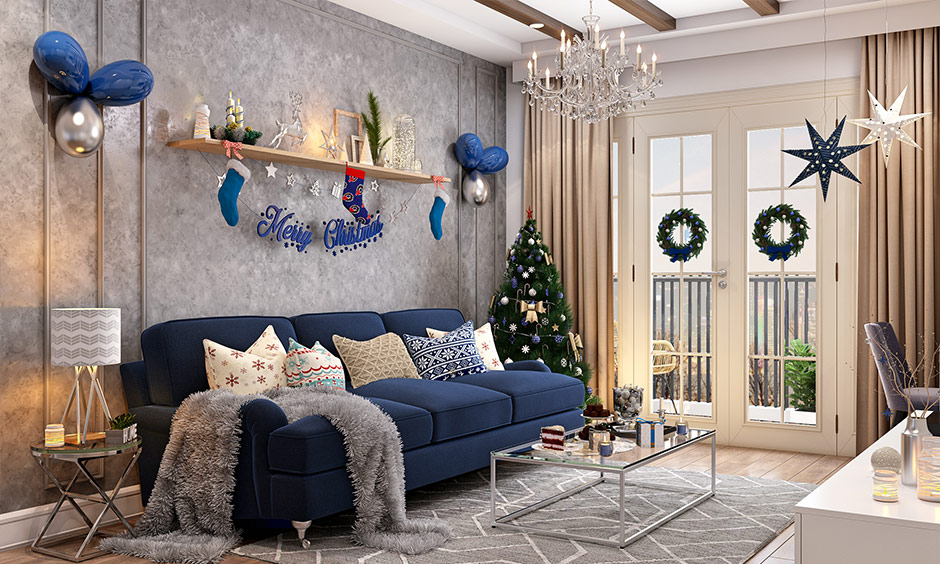 Home decor with blue and silver Christmas theme colors with wreaths and hanging stars.