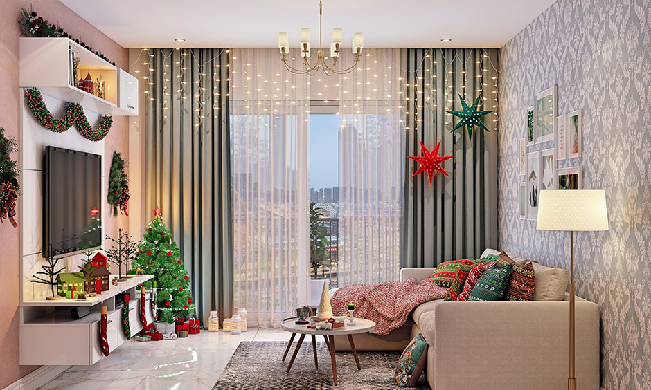 Red and green Christmas tree decorations in living room paired with a wreath on either side of the tv wall