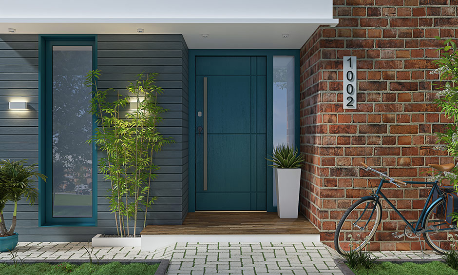 Modern teal wooden flush main door with a sleek design and simple handle, adding a contemporary touch to the entrance